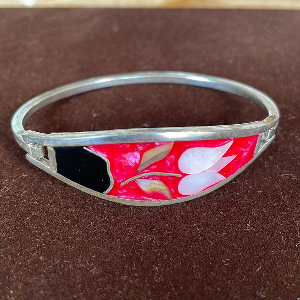 Silver bracelet with mother of pearl and onyx inlay.